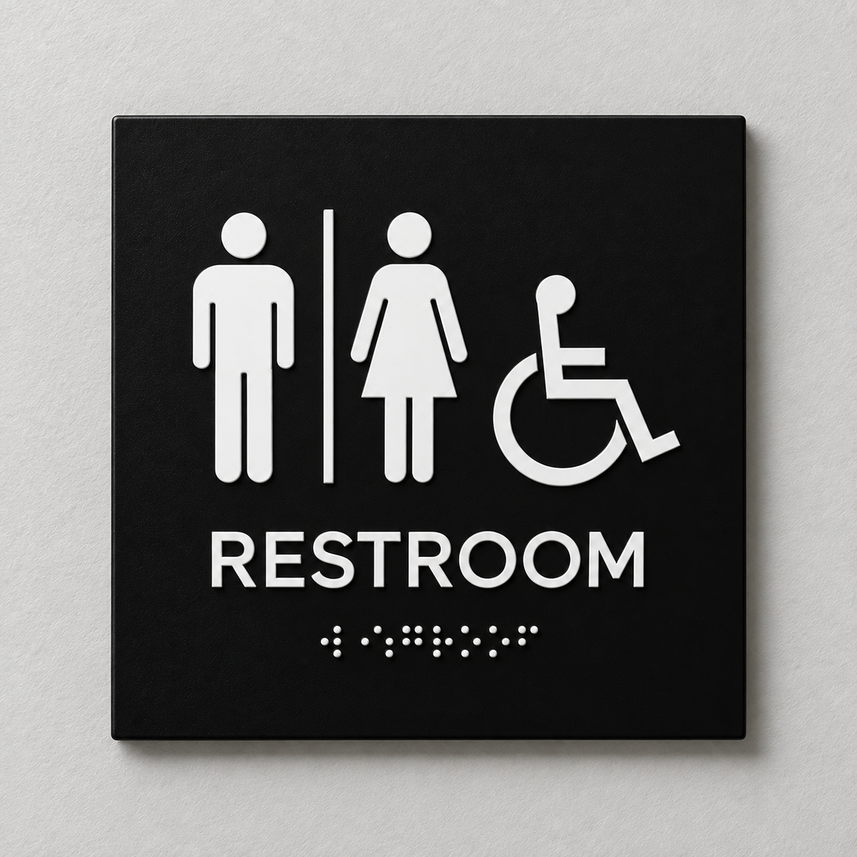 Black ADA restroom sign with White raised male, female and accessibility symbols, tactile RESTROOM text and Braille.