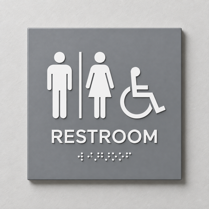 Grey ADA restroom sign with White raised male, female and accessibility symbols, tactile RESTROOM text and Braille