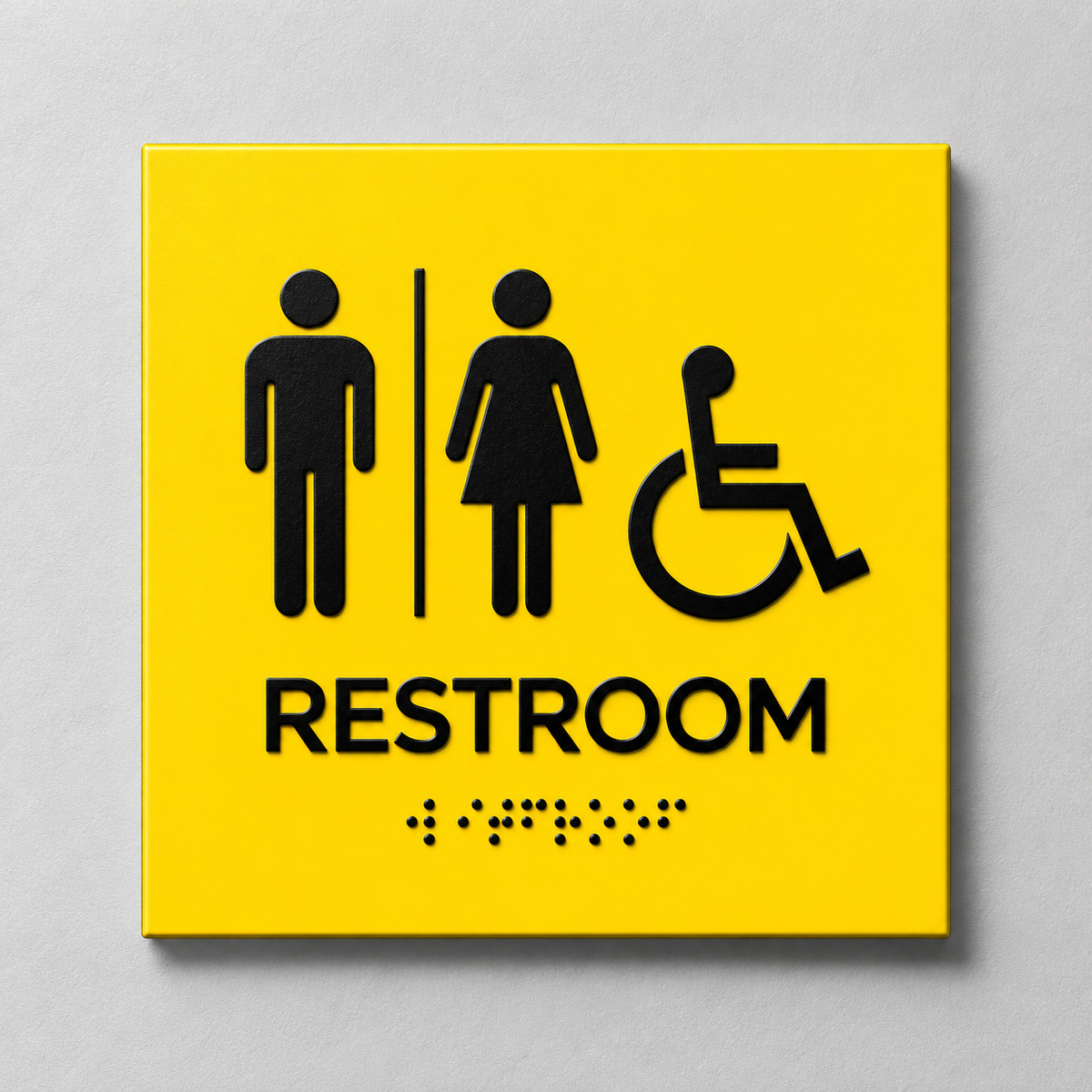 Yellow ADA restroom sign with black raised male, female and accessibility symbols, tactile RESTROOM text and Braille.
