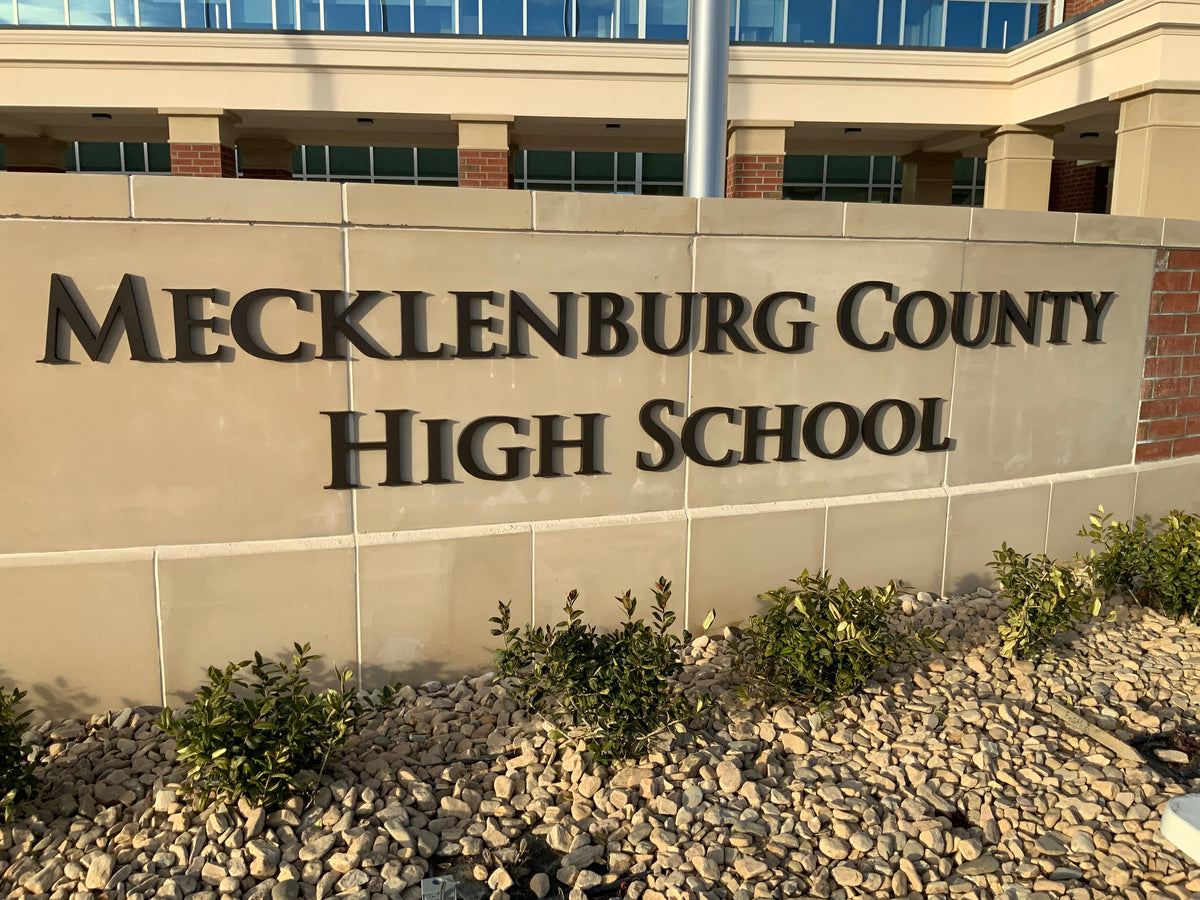 Exterior dimensional lettering for Mecklenburg County High School mounted on an architectural masonry entrance wall.